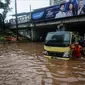 Petugas dibantu warga mendorong truk yang mogok akibat terjebak banjir di terowongan Dukuh Atas, Jakarta, Senin (11/12). Hujan lebat yang mengguyur ibu kota mengakibatkan genangan hingga satu meter di lokasi tersebut. (Liputan6.com/Faizal Fanani)