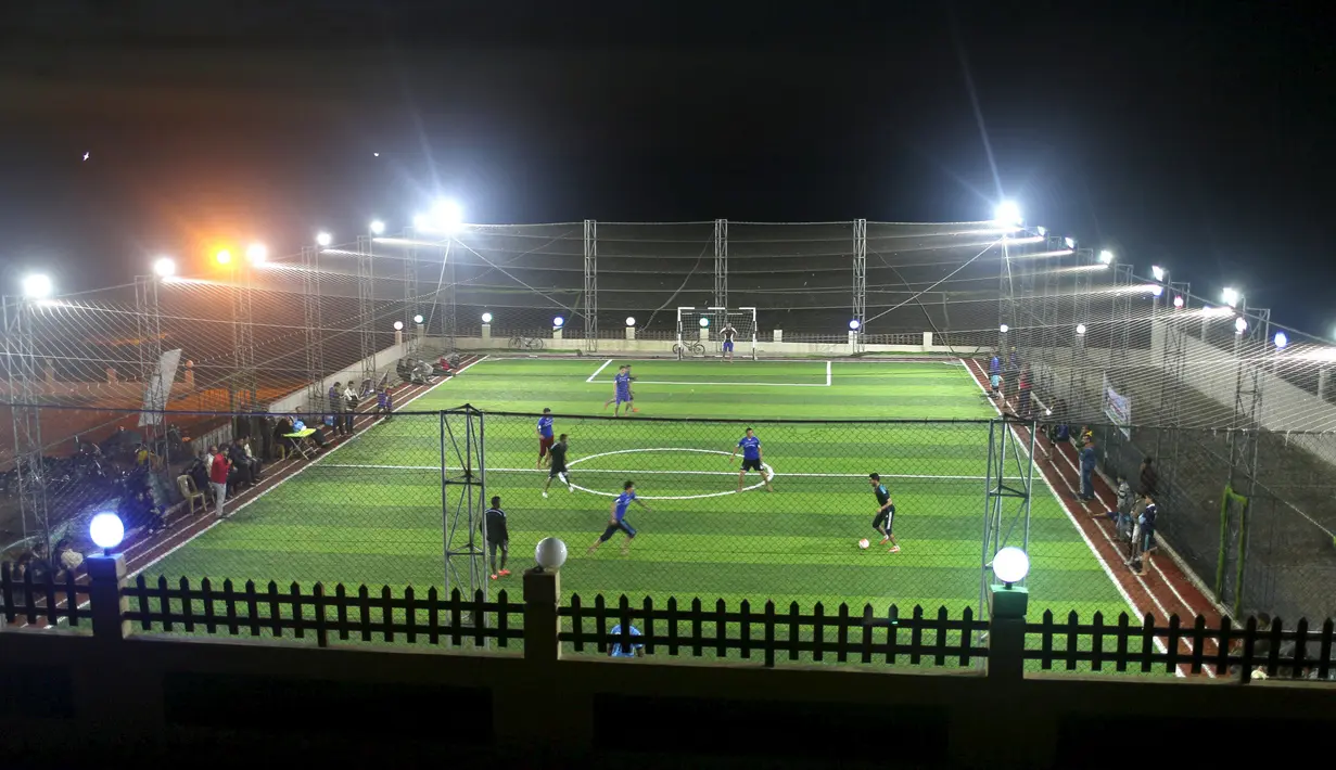 Warga Palestina bermain sepak bola di lapangan futsal, Khan Younis, Jalur Gaza, (4/6). Jalur Gaza merupakan kawasan konflik antara Israel dan Palestina. (REUTERS / Ibraheem Abu Mustafa)
