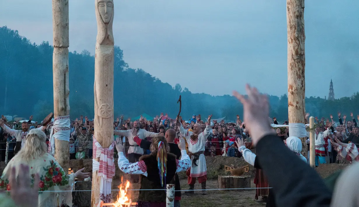 Sejumlah orang mengikuti upacara ritual pagan kuno di dekat desa Glubokovo, Rusia (24/6). Upacara ini digelar untuk merayakan titik balik matahari di musim panas. (AFP Photo/Andrei Borodulin)