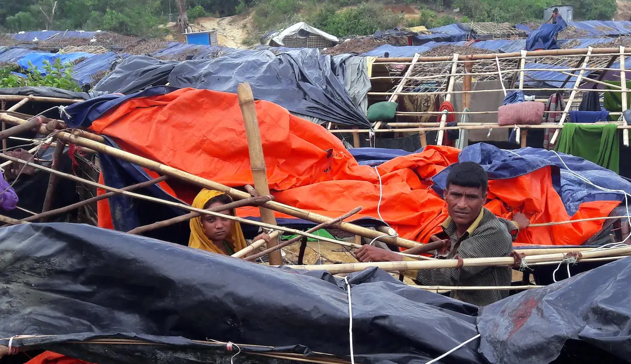 Pengungsi Rohingya membangun kembali rumah mereka yang dihancurkan oleh Topan Mora di sebuah kamp di distrik Cox's Bazar (31/5). Akibat bencana tersebut sekitar 300 orang terpaksa dievakuasi. (AFP Photo/Str)