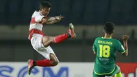 Gelandang Madura United, Zulfiandi (kiri) berebut bola dengan pemain Persebaya Surabaya, Kemalludin, dalam pertandingan Babak Penyisihan Piala Menpora 2021 Grup C di Stadion Si Jalak Harupat, Bandung, Minggu (28/3/2021). (Foto: Bola.com/M Iqbal Ichsan)