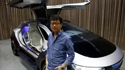CEO Singulato Motors, Shen Haiyin berpose di dekat mobil konsep Tigercar P0 pada lokakarya di Beijing, Tiongkok, Senin (7/11). Tigercar P0 memiliki pintu yang unik dengan desain futuristik. (REUTERS / Thomas Peter)