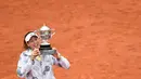 Garbine Muguruza mengangkat trofi usai kalahkan Serena Williams pada Final pada final Roland Garros 2016 Prancis Terbuka di Paris (4/6/2016). (AFP/Martin Bureau) 