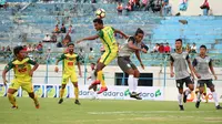 Bek Persela, Samsul Arifin, dan pemain Kedah FA, M. Akram Mahinan, berduel memperebutkan bola di Stadion Gelora Bangkalan, Bangkalan (8/1/2018). (Bola.com/Aditya Wany)
