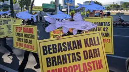 Aktivis dari Ecoton (Pengamatan Ekologi dan Konservasi Lahan Basah) yang mengenakan topeng ikan ikut serta dalam unjuk rasa menyerukan sungai bersih bebas sampah dan limbah industri, serta perlindungan ikan sungai, sebagai bagian dari perayaan Hari Lingkungan Hidup Sedunia di Surabaya, Jawa Timur, Jumat 5 Juni 2026. (JUNI KRISWANTO/AFP)