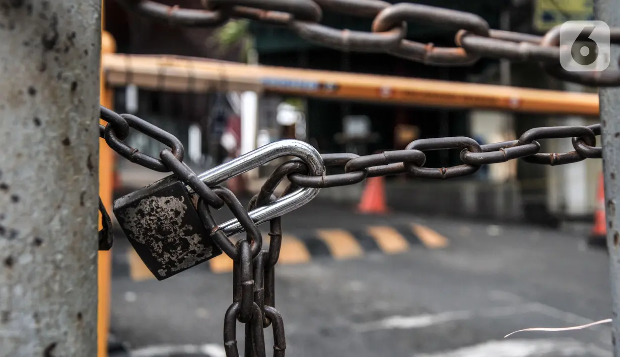 Gembok terpasang di pintu masuk Plaza Kenari Mas yang tutup, Jakarta, Rabu (7/7/2021). Pusat elektronik tersebut ditutup sejak 6 Juli hingga 20 Juli atau sampai berakhirnya masa PPKM Darurat. (merdeka.com/Iqbal S. Nugroho)