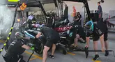 Para mekanik melakukan latihan pit stop dengan mobil pembalap Mercedes asal Inggris, Lewis Hamilton di Shanghai pada 18 April 2024. (Pedro PARDO/AFP)