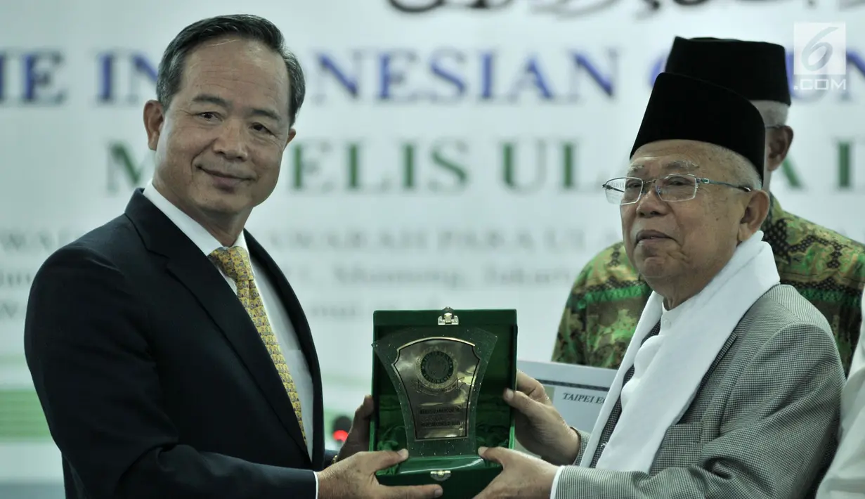 Ketua Umum MUI KH Ma'ruf Amin (kanan) memberi plakat kepada Kepala Perwakilan TETO John C. Chen di sela penyerahan bantuan untuk korban gempa dan tsunami Sulawesi Tengah di Kantor MUI, Jakarta, Selasa (9/10). (Merdeka.com/Iqbal Nugroho)