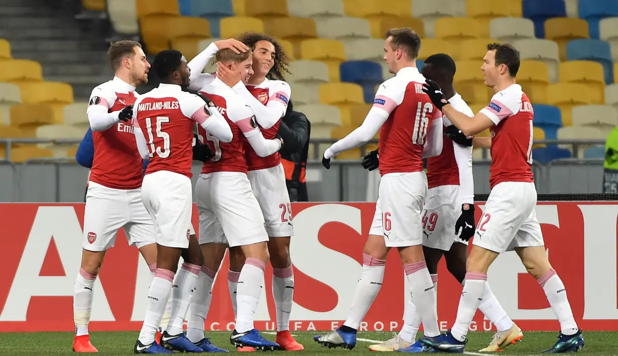 Pemain Arsenal merayakan gol pembuka yang dicetak oleh pemain muda, Emile Smith Rowe ke gawang Vorskla pada laga lanjutan Grup E Liga Europa yang berlangsung stadion NSK Olimpiyskiy, Kyiv, Jumat (30/11). Arsenal menang atas Vorskla 3-0. (AFP/Sergei Supins