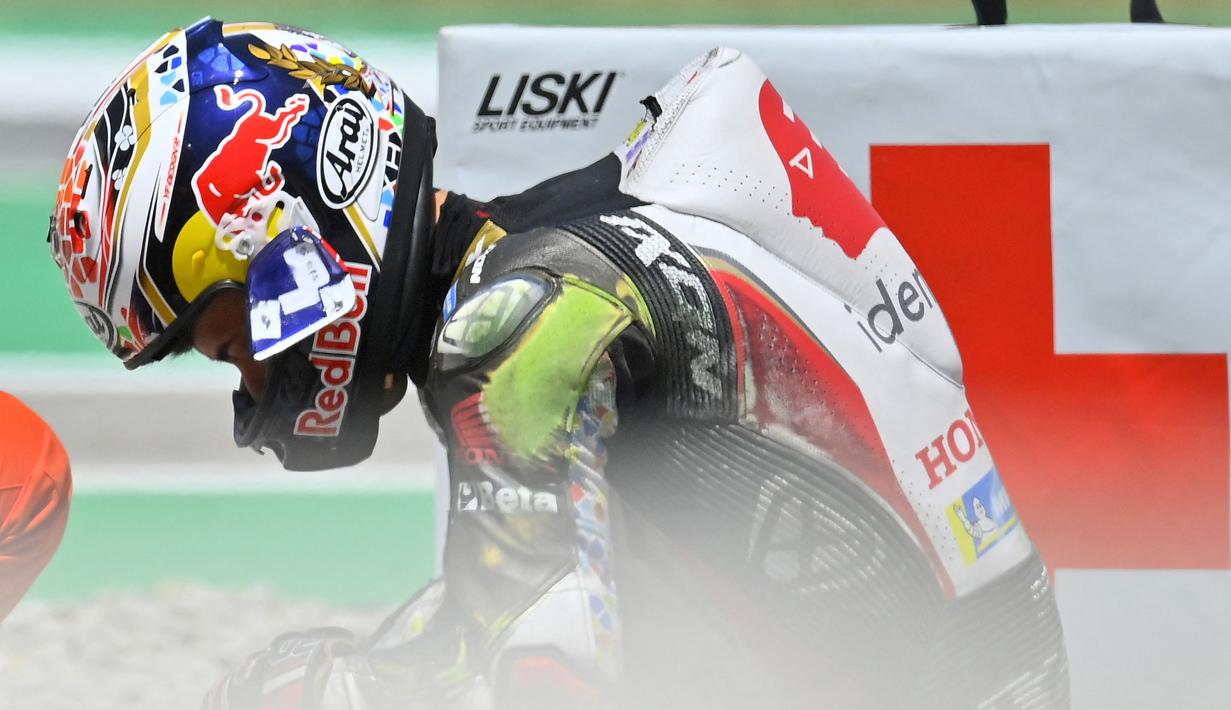 Terlihat visor dari pebalap asal Jepang, Nakagami terlepas usai menghantam ban belakang Pecco. (AFP/Pau Barrena)