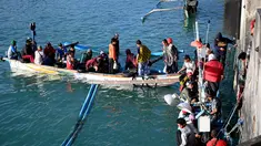 Sejumlah nelayan berbincang sebelum pergi memancing di Kedonganan, Denpasar, Bali (15/7/2019).  Desa Kedonganan terkenal dengan sektor Perikanan, dan juga Pantai Kedonganan yang indah. (AFP Photo/Sonny Tumbelaka)
