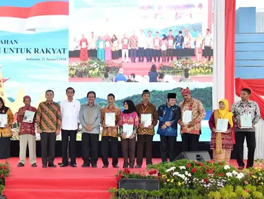 Presiden Jokowi foto bersama usai menyerahkan sertifikat kepada warga Lampung di Gedung Olah Raga (GOR) Way Handak, Kalianda, Lampung Selatan, Minggu (21/1). Jokowi membagikan 3.500 sertifikat. (Liputan6.com/Pool/Laily Rachev-Biro Pers Setpres)