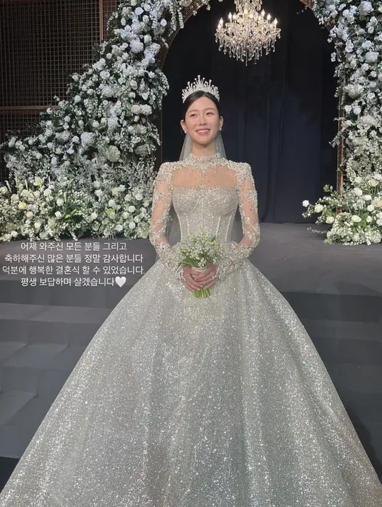 Lee Da In mengenakan bowl gown warna putih yang memiliki detail payetan lengkap dengan veil dan mahkotanya.  Credit: (@xx__dain)