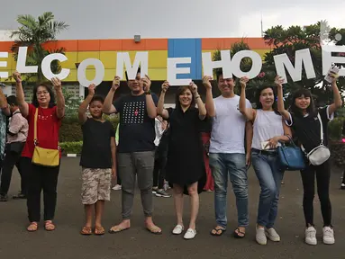 Keluarga membawa tulisan 'Welcome Home' saat menunggu WNI yang selesai menjalani observasi virus corona dari Natuna, di Bandara Halim Perdanakusuma, Jakarta, Sabtu (15/2/2020). Pemerintah resmi memulangkan 238 WNI ke daerah masing-masing karena telah dinyatakan sehat. (Liputan6.com/Herman Zakharia)