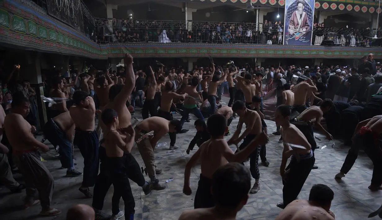  Umat Syiah Afghanistan mencambuk punggung meraka merayakan peringatan hari Asyura di sebuah masjid di Kabul (9/10). Kerumunan pria muslim mencambuk punggung mereka untuk memperingati kematian Imam Hussein, cucu Nabi Muhammad. (AFP PHOTO/SHAH Marai)