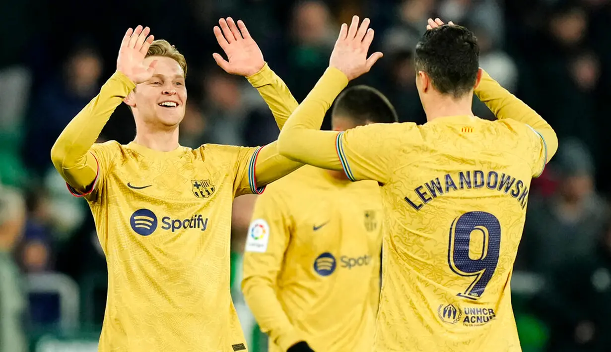 Pemain Barcelona Frenkie de Jong (kiri) dan rekan setimnya Robert Lewandowski merayakan kemenangan atas Real Betis pada akhir pertandingan sepak bola Liga Spanyol di Stadion Benito Villamarin, Seville, Spanyol, 1 Februari 2023. Barcelona genap mengoleksi 50 poin dan unggul 8 poin dari Real Madrid usai menang 2-1 atas Real Betis pada lanjutan Liga Spanyol. (AP Photo/Jose Breton)