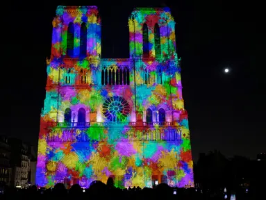 Sebuah foto pada 20 Oktober 2018 menunjukkan Gereja Katedral Notre Dame selama pertunjukan cahaya berjudul "Dame de Coeur" di Paris, Prancis. Pertunjukan cahaya tersebut bagian dari perayaan seratus tahun Perang Dunia I. (Photo by Ludovic MARIN/AFP)