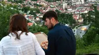 Pasangan Muslim Bosnia duduk menghadap ke kota sambil menunggu berbuka puasa pada hari pertama bulan suci Ramadan, di Sarajevo, (16/5). Muslim Bosnia mencapai sekitar 40 persen dari penduduk Bosnia 3,8 juta. (AFP Photo/Elvis Barukcic)