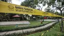 Garis batas terpasang mengelilingi taman saat pemberlakuan karantina wilayah skala kecil atau mini lockdown di RT 011 RW 009, Kelurahan Kayu Putih, Pulogadung, Jakarta Timur, Minggu (6/6/2021). Sisa warga yang positif COVID-19 menjalani isolasi di rumah masing-masing. (merdeka.com/Iqbal S. Nugroho)