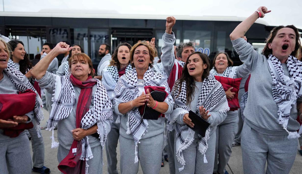 Para aktivis kemanusiaan Global Sumud Flotilla (GSF) meneriakkan slogan-slogan saat tiba di Bandara Istanbul, Turki, Kamis 21 Mei 2026. (AP Photo/Emrah Gurel)