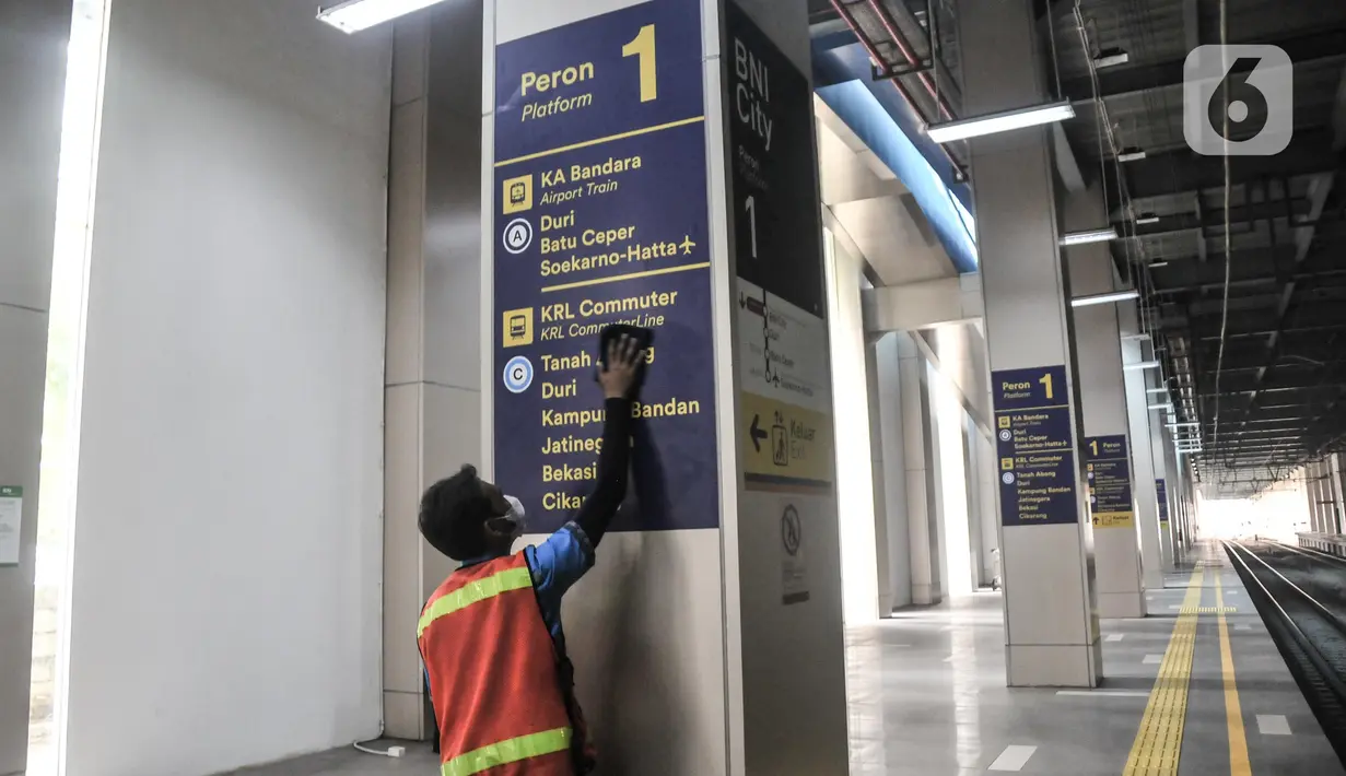 Petugas membersihkan papan penunjuk arah untuk layanan penumpang KRL di tiap sudut Stasiun BNI City, Dukuh Atas, Jakarta Pusat, Senin (25/7/2022). PT Kereta Commuter Indonesia (KCI) berencana menjadikan Stasiun BNI City yang sebelumnya khusus melayani penumpang kereta Bandara Soekarno-Hatta untuk pemberhentian KRL seiring akan dinonaktifkannya Stasiun Karet. (merdeka.com/Iqbal S Nugroho)