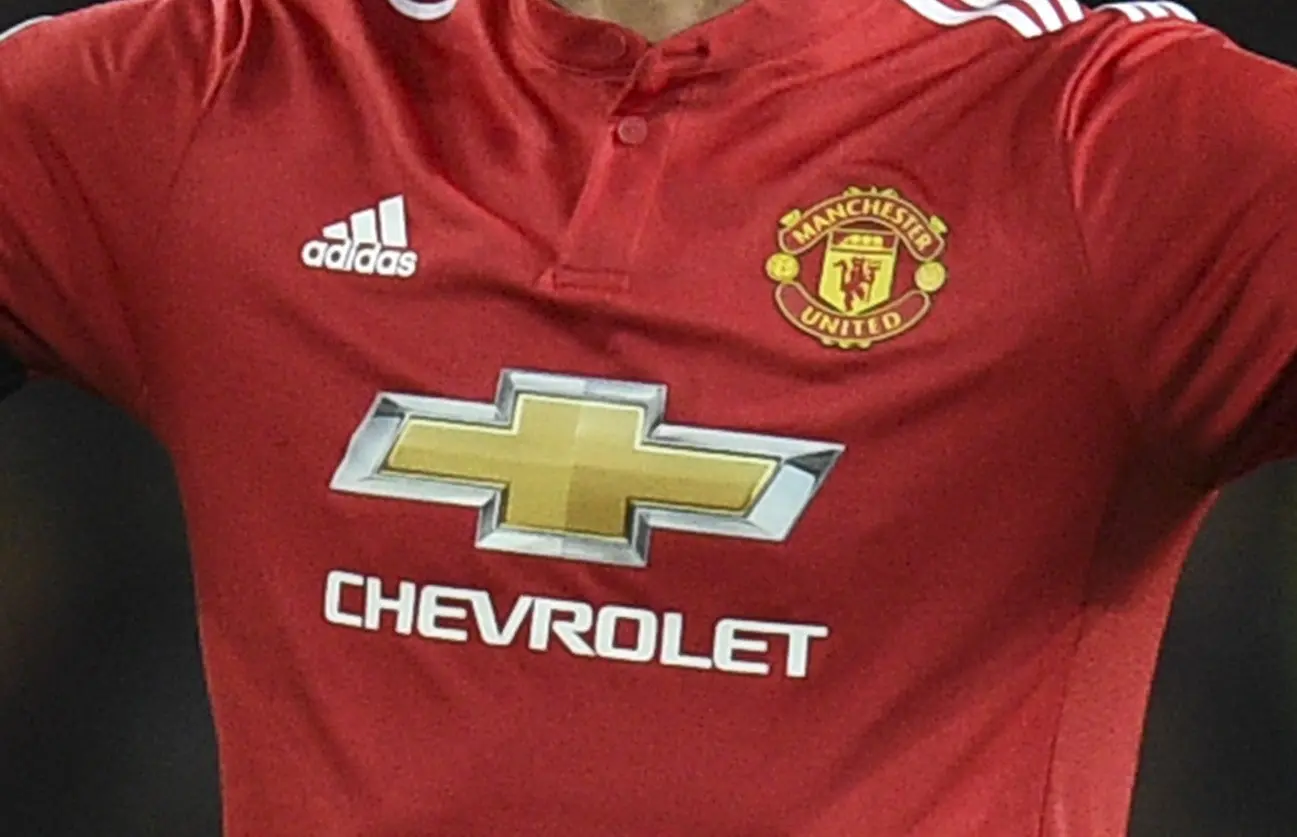 Manchester United dengan adidas. (AFP/Oli Scarff)