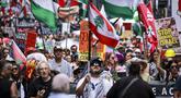 Para demonstran pro-Palestina membawa bendera, spanduk, dan plakat saat mereka berbaris berunjuk rasa di jalanan kota Sydney, Australia, Minggu 22 Februari 2026. Ribuan demonstran pro-Palestina kembali berkumpul memenuhi salah satu ruas jalan di Sydney, Australia. (DAVID GRAY/AFP)