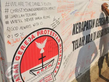 Warga membubuhkan tanda tangannya sebagai bentuk penolakan penggusuran Gereja Protestan Minahasa di kawasan Pacuan Kuda, Pulomas, Jakarta, Senin (18/4/2016). (Liputan6.com/Gempur M Surya) 
