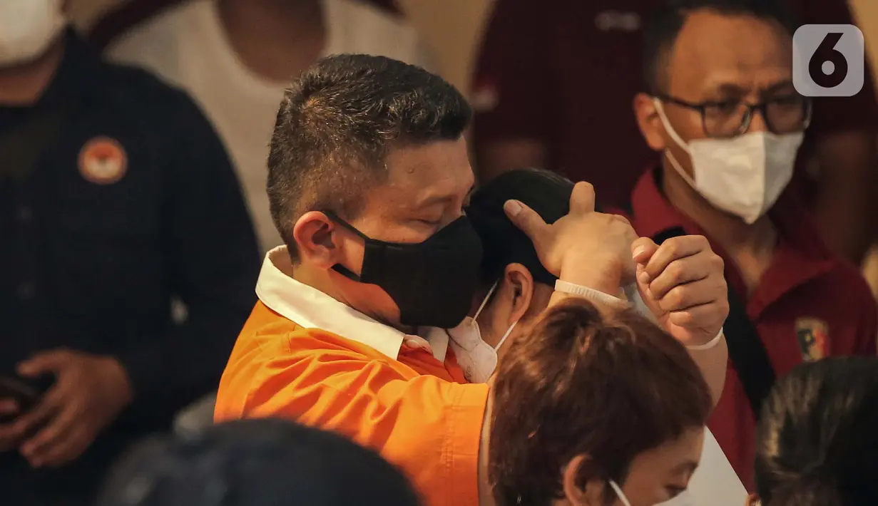 Irjen Ferdy Sambo memeluk erat istrinya, Putri Candrawathi, saat rekonstruksi pembunuhan berencana terhadap Nofriansyah Yosua Hutabarat atau Brigadir J di rumah dinas Duren Tiga, Jakarta, Selasa (30/8/2022). Sambo mengenakan baju tahanan oranye dan istrinya mengenakan baju berwarna putih. (Liputan6.com/Faizal Fanani)