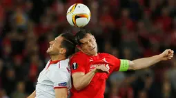 Gelandang Liverpool, James Milner (kanan) berebut bola udara dengan gelandang Sevilla, Grzegorz Krychowiak pada final Liga Europa di Basel, Swiss (19/5). Sevilla meraih tiga kali gelar juara Piala UEFA secara berturut-turut. (Reuters/Marcelo del Pozo)