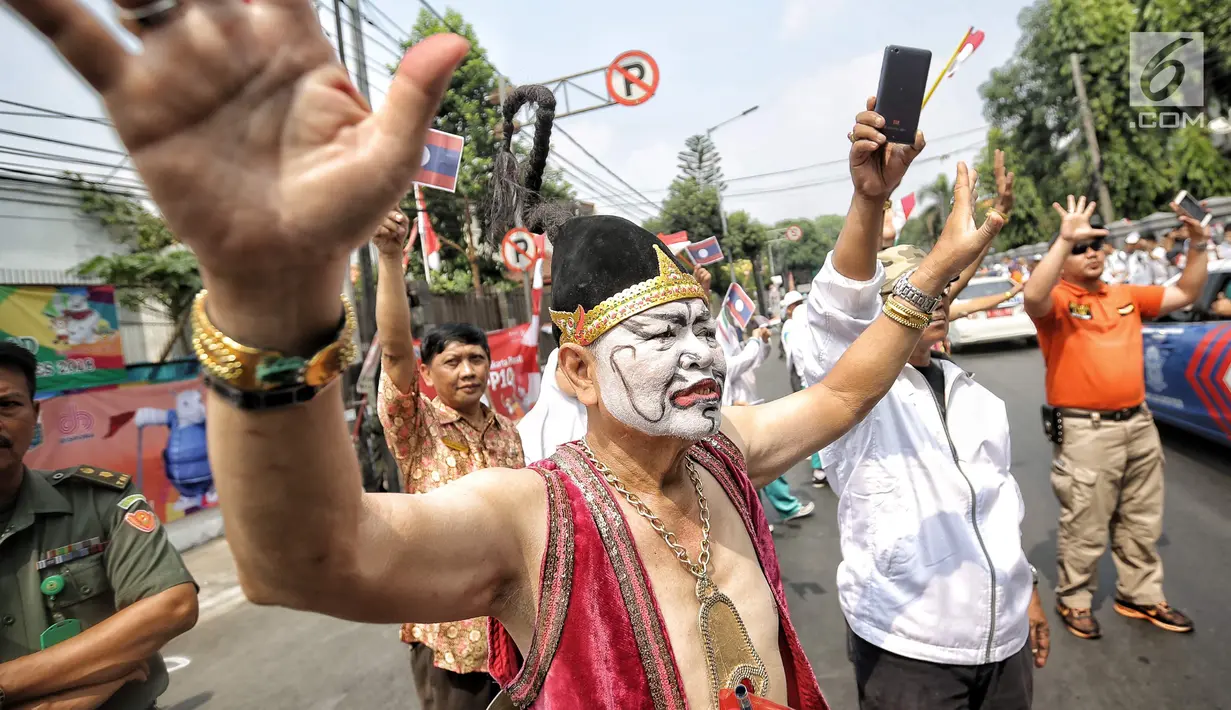 Pawai obor yang memasuki hari kedua dimulai dari Balai Kota DKI Jakarta dan berakhir di Gor Sunter di sambut meriah masyarakat jakarta dengan menggunakan wayang orang. (Liputan6.com/Faizal Fanani)