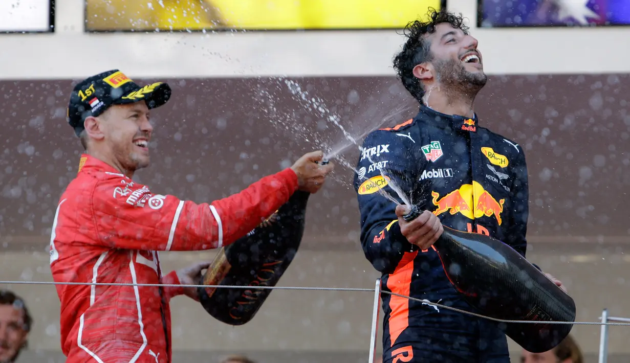 merayakan kemenangannya pada balapan GP Monaco di Sirkuit Monte Carlo, Minggu (28/5). Vettel unggul atas rekan setim Kimi Raikkonen dan penunggang Red Bull Racing, Daniel Ricciardo. (AP Photo/Claude Paris)