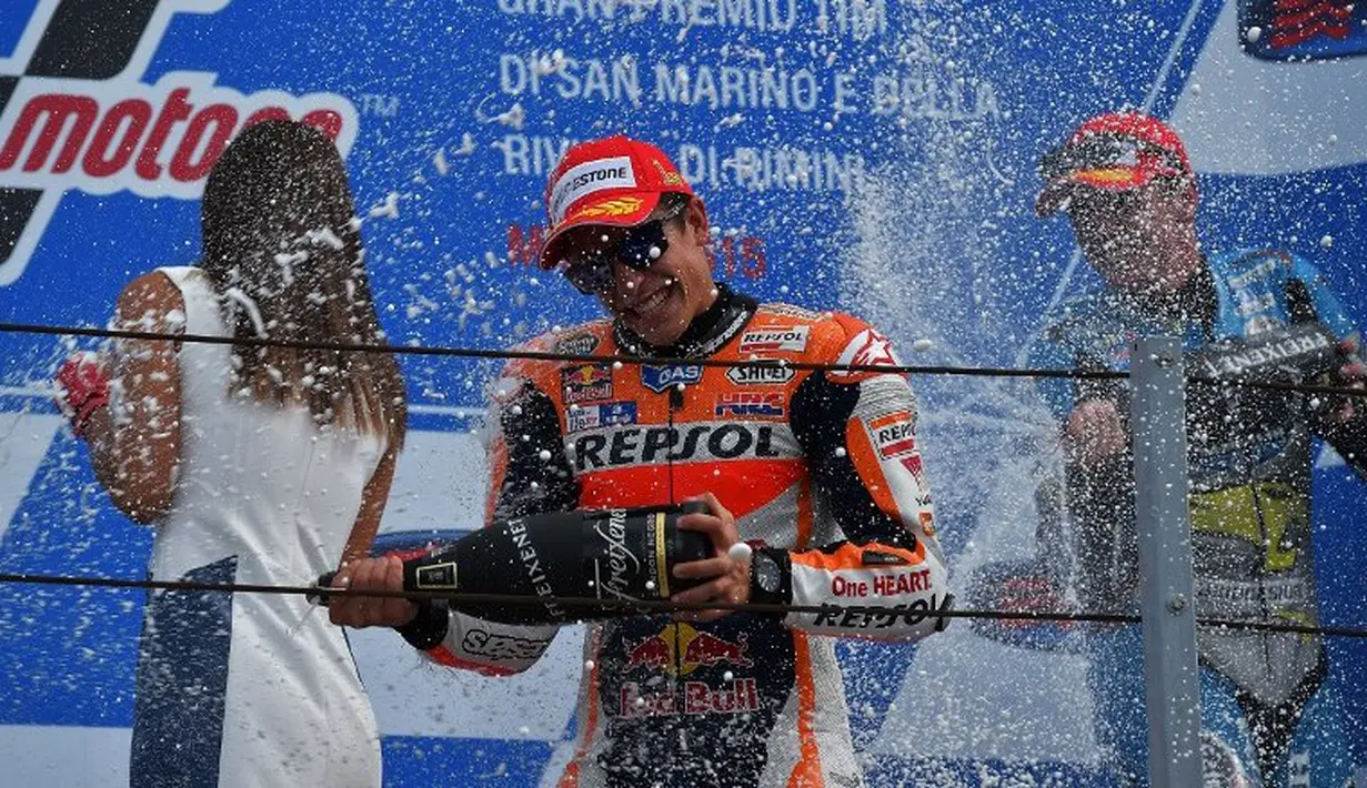 Marc Marquez merayakan kemenangan perdananya di MotoGP San Marino di Sirkuit Misano, Minggu (13/9/2015). (AFP Photo/Vincenzo Pinto)