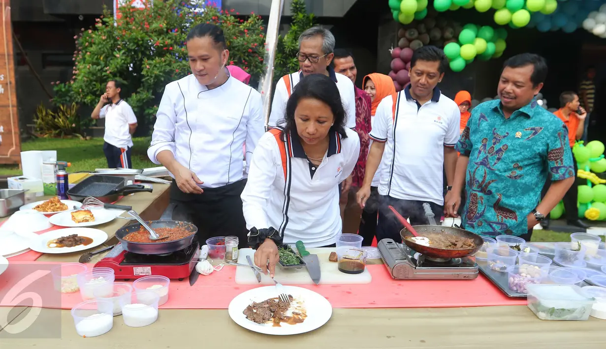 Menteri BUMN Rini Soemarno mencicipi daging kerbau hasil olahan seorang chef pada acara sosialisasi di Kantor Perum Bulog, Jakarta, Jumat (2/9). Sosialisasi ini dibuka dengan kegiatan senam ceria bersama seluruh pegawai Bulog. (Liputan6.com/Angga Yuniar)