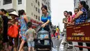 Warga membawa wadah berisi air usai mengisinya dari truk tangki pasokan pemerintah di Hanoi, Vietnam, Kamis (17/10/2019). Warga Hanoi melaporkan bahwa air ledeng yang mereka gunakan bau plastik terbakar. (Nhac NGUYEN/AFP)