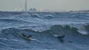 Diketahui, berselancar di Gaza merupakan hal baru, berbeda dengan pantai-pantai terkenal California, Australia, atau Afrika Selatan. Tampak dalam foto, warga Palestina, Khalil Abu Jayyab (kanan) dan Tahseen Abu Assi berselancar di pantai Kota Gaza, Minggu, 28 Desember 2025. (AP Photo/Jehad Alshrafi)