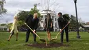 Presiden AS Donald Trump bersama Presiden Prancis Emmanuel Macron menggunakan saat upacara penanaman pohon di South Lawn Gedung Putih, Washington (23/4). (AFP Photo / Jim Watson)