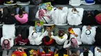 Penonton memegang foto pemain sepak bola timnas Jerman Mesut Ozil di tribun selama pertandingan Spanyol vs Jerman pada laga Grup E Piala Dunia 2022  di Stadion Al Bayt, Kota Al Khor pada Senin (28/11/2022) dini hari WIB. Dalam laga tersebut terlihat banyak foto Mesut Ozil, yang dibawa oleh penonton-penonton di tribun. (AP Photo/Petr David Josek)