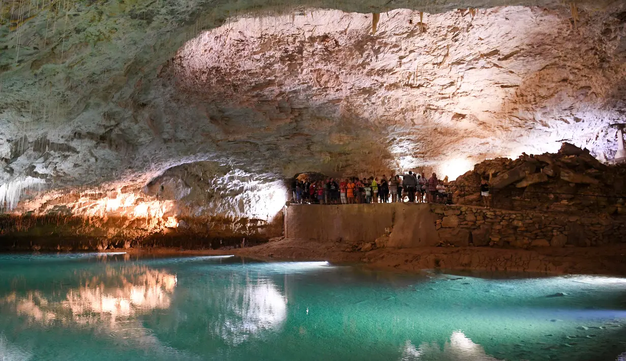 Pengunjung berada di dalam gua alam Choranche, di wilayah Vercors dekat Grenoble, Prancis (3/8). Selain mencari situs alam yang indah, pengunjung juga mencari kesegaran bawah tanah dengan suhu sekitar 15 derajat celcius. (AFP Photo/Jean-Pierre Clatot)