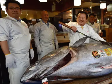 Pengusaha restoran sushi Jepang, Kiyoshi Kimura memamerkan ikan tuna sirip biru seberat 278 kg di restorannya, Tokyo, Sabtu (5/1). Tuna raksasa itu dibeli dalam lelang perdana 2019 dengan harga USD3,1 juta atau setara 43,4 miliar. (Kazuhiro NOGI/AFP)