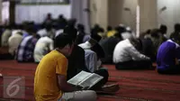 Seorang jamaah bertadarus pada hari pertama Ramadan 1437 H di Masjid Istiqlal, Jakarta, Senin (6/6). Bulan Ramadan, umat muslim memanfaatkan waktu memperbanyak ibadah dengan tadarus dan melaksanakan salat sunah. (Liputan6.com/Faizal Fanani)