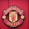 Logo Manchester United atau MU di Stadion Old Trafford. (Oli SCARFF / AFP)