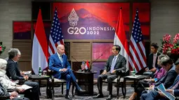 Presiden Joko Widodo berbincang dengan Presiden Amerika Serikat (AS) Joe Biden saat melakukan pertemuan bilateral di Nusa Dua, Bali (14/11/2022). Pertemuan itu diikuti oleh sejumlah pejabat yang mendampingi. (AFP/Saul Loeb)