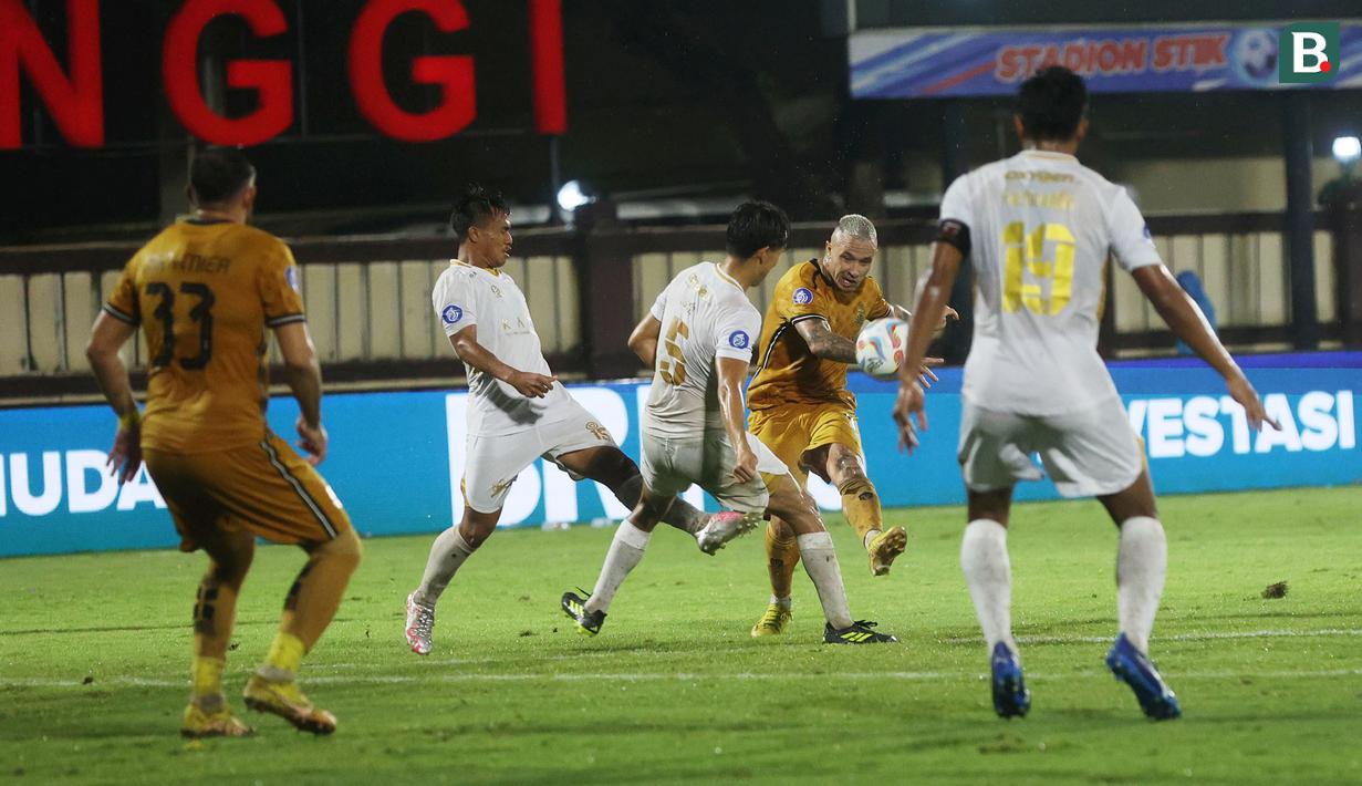 <p>Pemain Bhayangkara FC, Radja Nainggolan (kedua kanan) melepaskan tendangan yang berusaha diblok dua pemain Madura United pada laga pekan ke-27 BRI Liga 1 2023/2024 di Stadion STIK, Jakarta Selatan, Jumat (1/3/2024). (Bola.com/M Iqbal Ichsan)</p>