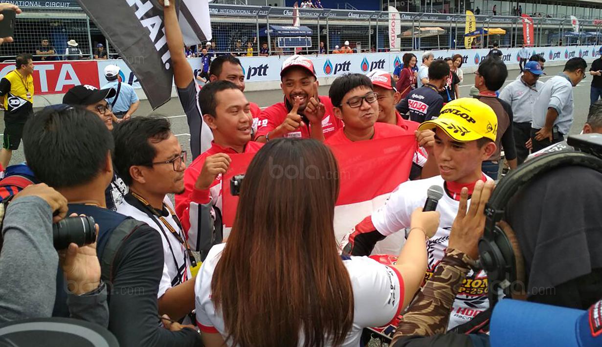 Pebalap Astra Honda Racing Team, Gerry Salim, melakukan wawancara usai ARRC 2017 di Sirkuit Buriram, Thailand, Sabtu (2/12/2017). Gerry Salim menjadi rider Indonesia pertama yang menjuarai ARRC kelas Asia Production 250. (Bola.com/Muhammad Wirawan)
