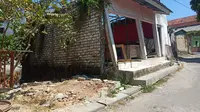 Salah satu bangunan warga di Kelurahan Rongtengah Kota Sampang yang mengalami kemiringan dan hampir roboh dampak proyek normalisasi sungai Kemuning. (Liputan.com/Musthofa Aldo)