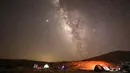 Meteor Perseid melintas di langit di atas lokasi perkemahan di gurun Negev dekat kota Mitzpe Ramon, Israel pada 11 Agustus 2020. Hujan meteor ini terjadi setiap tahun sekitar bulan Agustus, saat Bumi melayang melalui awan yang ditinggalkan oleh komet raksasa 109P / Swift-Tuttle. (MENAHEM KAHANA/AFP)