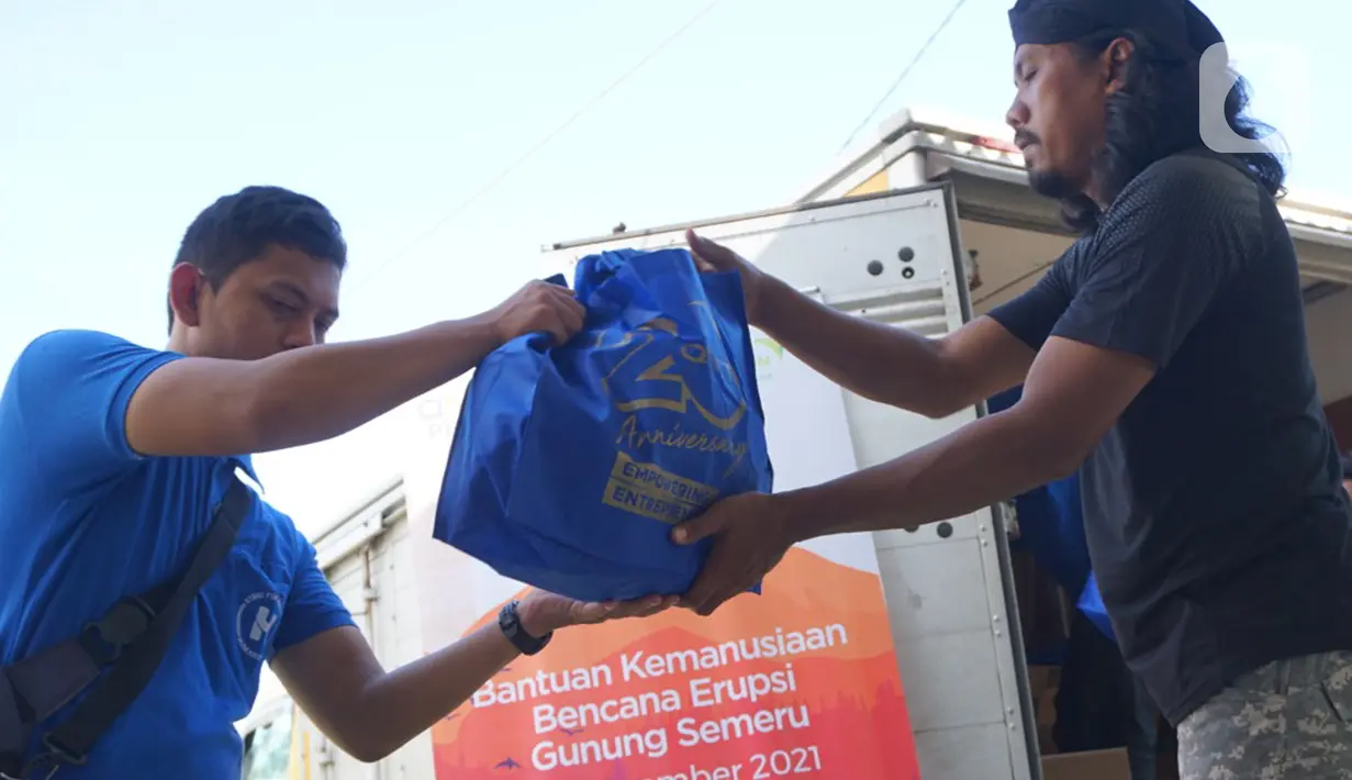 Relawan QNET mendistribusikan bantuan makanan kepada warga terdampak erupsi Gunung Semeru di Kabupaten Lumajang, Jawa Timur (25/12/2021). Bantuan makanan dari QNET melalui RYTHM Foundation juga ditujukan kepada warga yang tidak tertampung di tenda-tenda pengungsian. (Liputan6.com/HO/QNET)