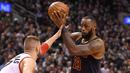 Pemain Cleveland Cavaliers, LeBron James #23 berusaha melewati hadangan pemain Raptors, Jonas Valanciunas #17 pada laga NBA di Air Canada Centre, (6/12/2016). (Reuters/Dan Hamilton-USA TODAY Sports)