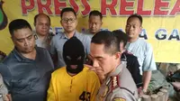 Faisal Amir orangtua yang tega membunuh anak bayinya saat digelandang di kepolisian. (Liputan6.com/Moch Harun Syah)